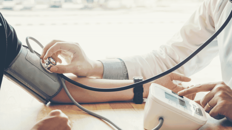 Doctor measuring patient's blood pressure during medical consultation