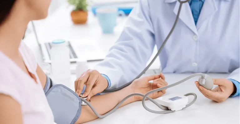 Doctor measuring patient's blood pressure during medical consultation