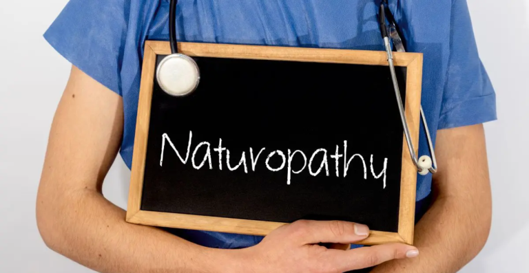 Healthcare professional holding sign that says Naturopathy
