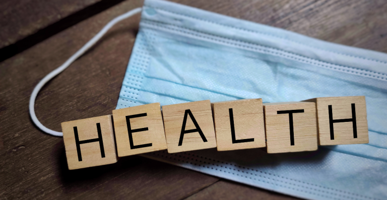Wooden blocks spelling the word HEALTH on a table