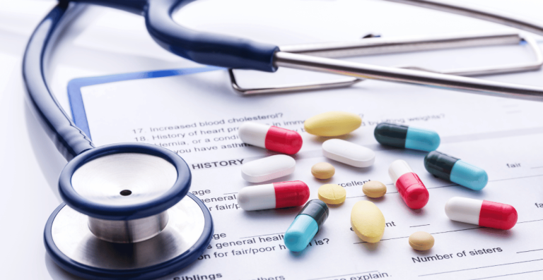 Stethoscope and various medications on medical report
