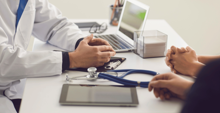 Doctor reviewing health report with patient during consultation