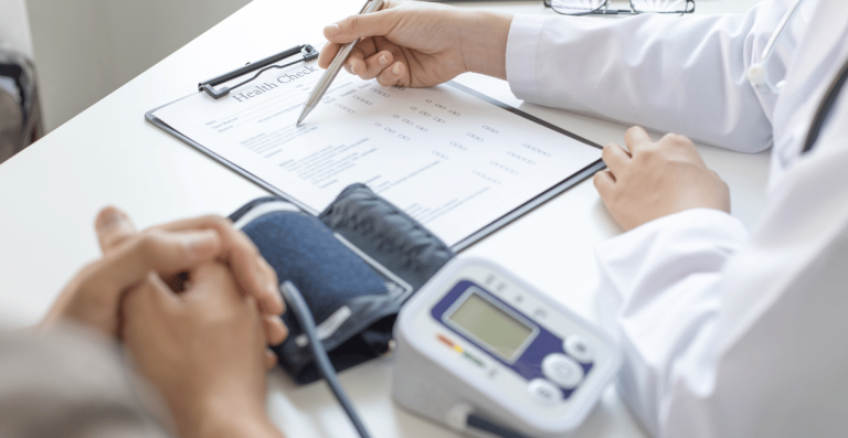 Doctor reviewing health report with patient during consultation