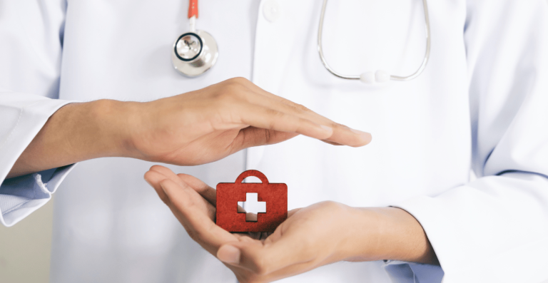 Doctor holding a small red medical kit symbolizing healthcare