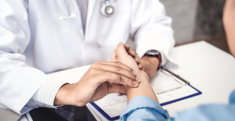 Doctor checking a patient's pulse during consultation