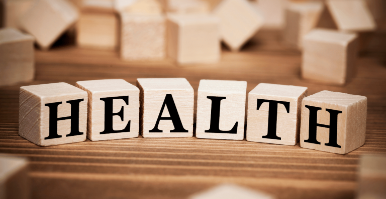 Wooden blocks spelling the word HEALTH on a table