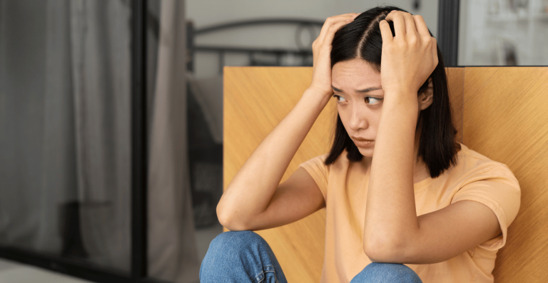 Young woman looking stressed and confused about unexplained weight gain