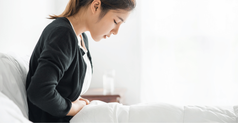 Woman experiencing abdominal bloating before menstruation