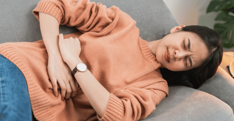 Woman experiencing abdominal discomfort related to inflammation